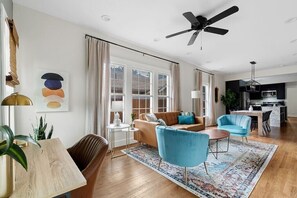 Relax in this inviting living space with a sofa, armchair, and coffee table.