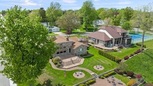 A large house with a spacious backyard, including a tennis court and a patio area. - Harbor View! Walk Out The Door Into Downtown Lex! (Lexington)