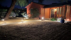 A landscaped garden with a pathway leading to a building with a modern design.