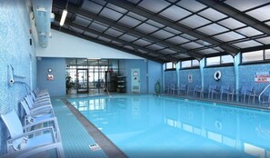 Relax by the pool with a clear view of the water and comfortable seating.