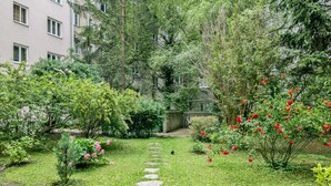 Un jardín con un sendero de piedra que lleva a la entrada de un edificio.