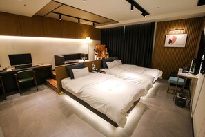 A modern hotel room with a large bed, a desk with a computer, a chair, and a TV. - Chungjangro 1st Boutique Hotel (Gwangju)