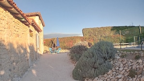 A gravel path leading to a rustic stone building with a tiled roof. - Chez Goret Gites - Gite Skippy  Couples only (Nouvelle- Aquitaine)