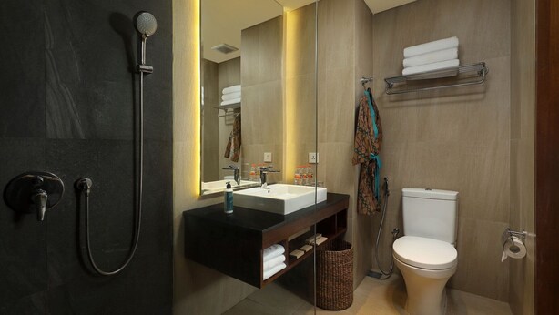 A modern bathroom with a shower, sink, and toilet. - Anja Jimbaran (Jimbaran)