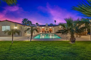 A house with a swimming pool, palm trees, and a patio area with chairs. - Hacienda Miranda - Private lighted Pickleball Court- Family Home (Palm Springs)