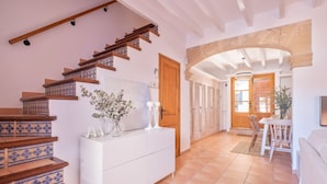 A modern interior with a staircase, a dining area, and a kitchen.