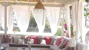 An outdoor seating area with a stone floor, a sofa set, and a dining table. - Villa 100 M From THE Beach 6 Room IN IOS Island (Ios)