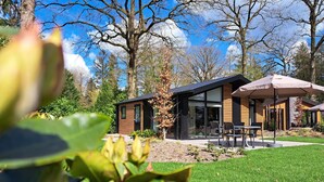 Una casa moderna con un patio, una mesa de comedor y sillas.