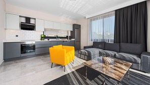 A modern living room with a sofa, a coffee table, and a bright yellow chair.