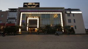 A hotel with a prominent entrance, a sign for 'The BrewMaster Arista Micro-Brewery', and a well-lit facade. - Treebo Premium Arista (Mohali)