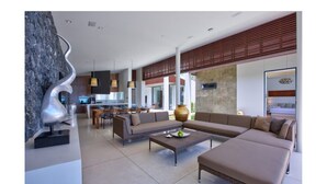A modern living room with a sofa set, a coffee table, and a decorative sculpture. - Beachfront Villa . Private Beach & Pool. 3 bedrooms.  Housekeeper included . (Koh Samui)