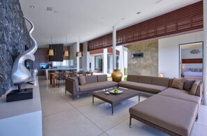 A modern living room with a sofa set, a coffee table, and a decorative sculpture. - Beachfront Villa . Private Beach & Pool. 3 bedrooms.  Housekeeper included . (Koh Samui)