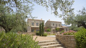 A stone building with a garden and steps leading to the entrance. - Liodentra (West Mani)