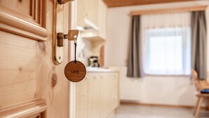 Une porte en bois avec une enseigne ronde portant l’inscription « LAITE » et un trou de serrure.