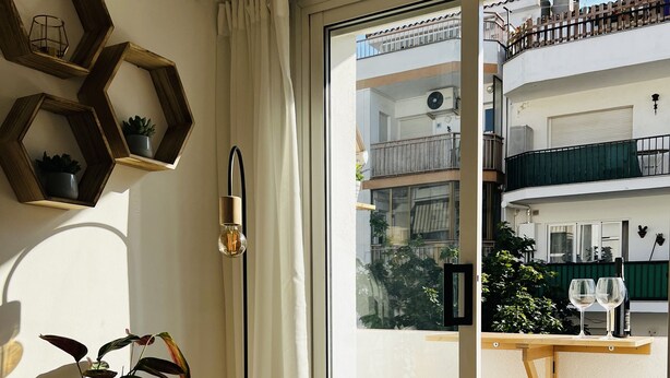 A room with a sliding glass door leading to an outdoor balcony with two round tables and chairs. - Charming apartment in Tossa de Mar (Tossa de Mar)