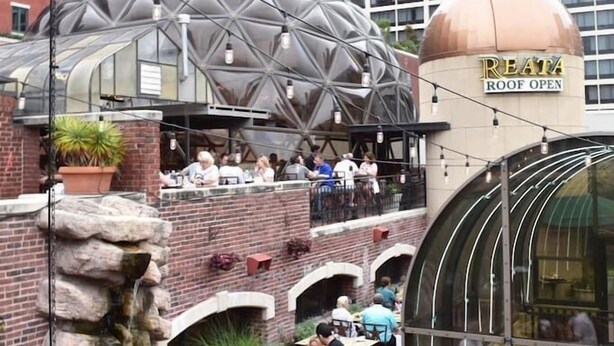 A rooftop restaurant with a dome structure and a sign reading "REATA ROOF OPEN". - New Lux Loft in Sundance Square Downtown FTW (Fort Worth)