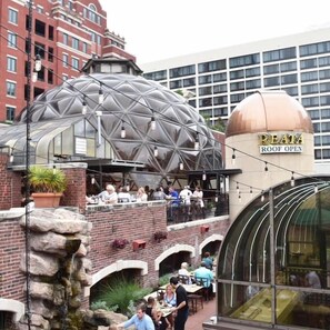 A rooftop restaurant with a dome structure and a sign reading "REATA ROOF OPEN". - New Lux Loft in Sundance Square Downtown FTW (Fort Worth)