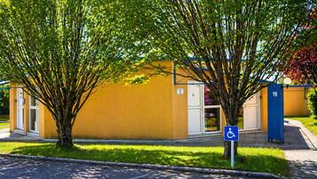 A building with a wheelchair accessibility sign, a number 19 sign, and a door labeled '1'.
