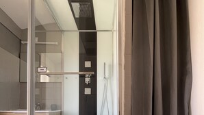 A glass-enclosed shower with a control panel, a towel rack, and a sign labeled "TIMER". - Apartment in the center of Castelnaudary (Castelnaudary)