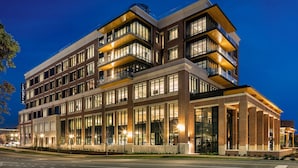A multi-story hotel with a modern architectural design, featuring large windows and balconies. - Laurel Hotel and Spa (Auburn)
