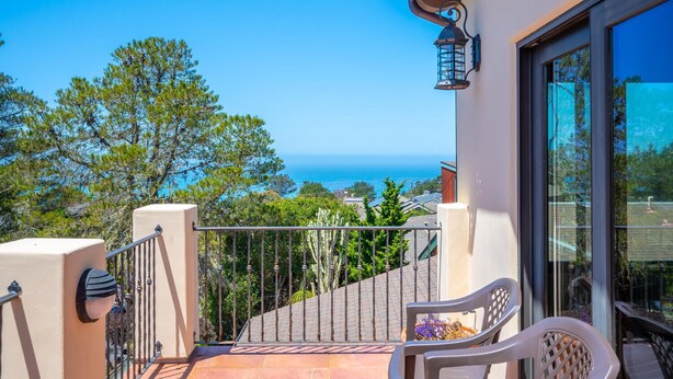 A balcony with a view of the sea, a chair, and a lamp. - Stunning 3 bed/2.5 bath Mediterranean Villa with FABULOUS Ocean Views! (Cambria)