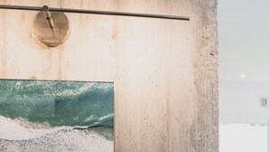 En vägg av trä med en inramad bild som föreställer en strandvy.