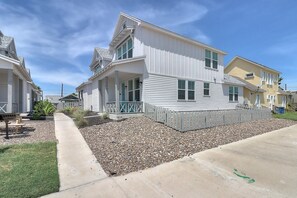 A residential area with houses featuring a similar architectural style, including white siding and gabled roofs. - The best vacation memories are made at the beach! Golf cart available for rent, (Port Aransas)