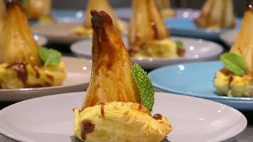 Presentación de postres con hojaldres triangulares en platos.