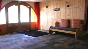 A wooden room with a bed, a bench, and a door. - L' IDEAL at Ecrin des Neiges. (Vars)