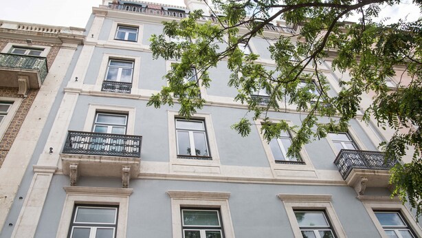 A multi-story building with balconies and windows.