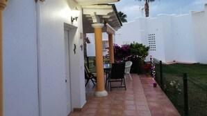 A patio with a tiled floor, a pergola, outdoor furniture, and a Christmas tree. - Beautiful, cozy vacation home on the Costa Calida, Andalusia 5 min. to the beach (San Juan de los Terreros Andalucia)