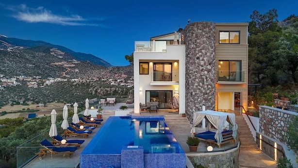 A modern two-story house with a swimming pool, outdoor seating, and a view of the surrounding landscape. - Luxury Villa in Kisla, Kalkan Within Walking Distance to the Beach (Kalkan)