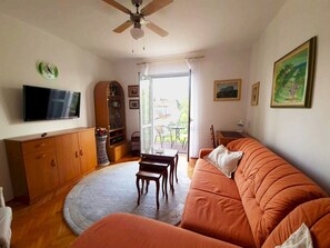City Apartment (1 Bedroom) | Living room | 103-cm Smart TV with digital channels, TV, streaming services