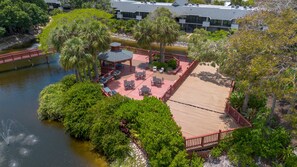A riverside patio with outdoor seating and a gazebo. - Stunning Second Floor Park Shore Resort Unit 223 (Naples)