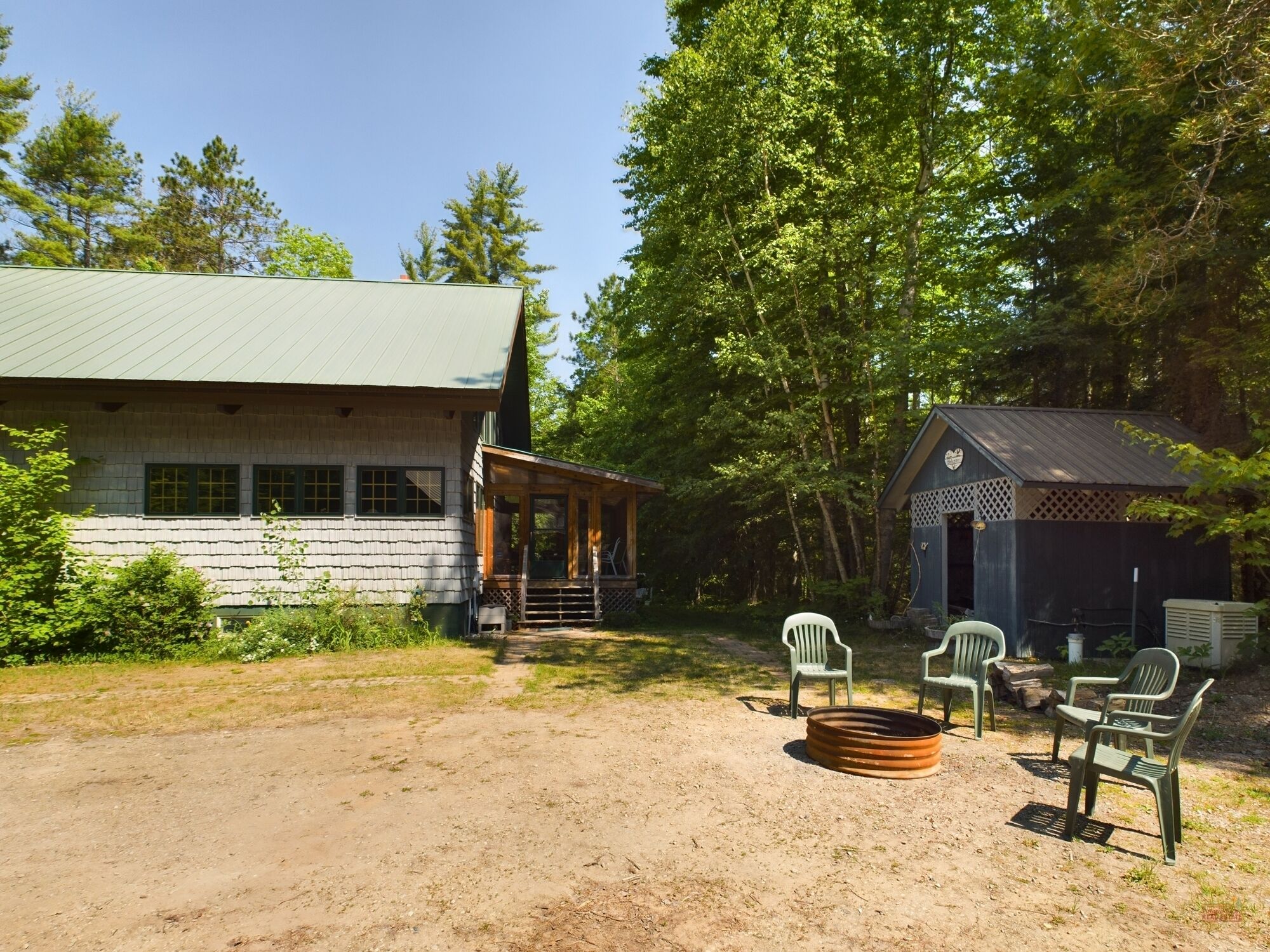 A rustic cabin with a porch and outdoor seating area.