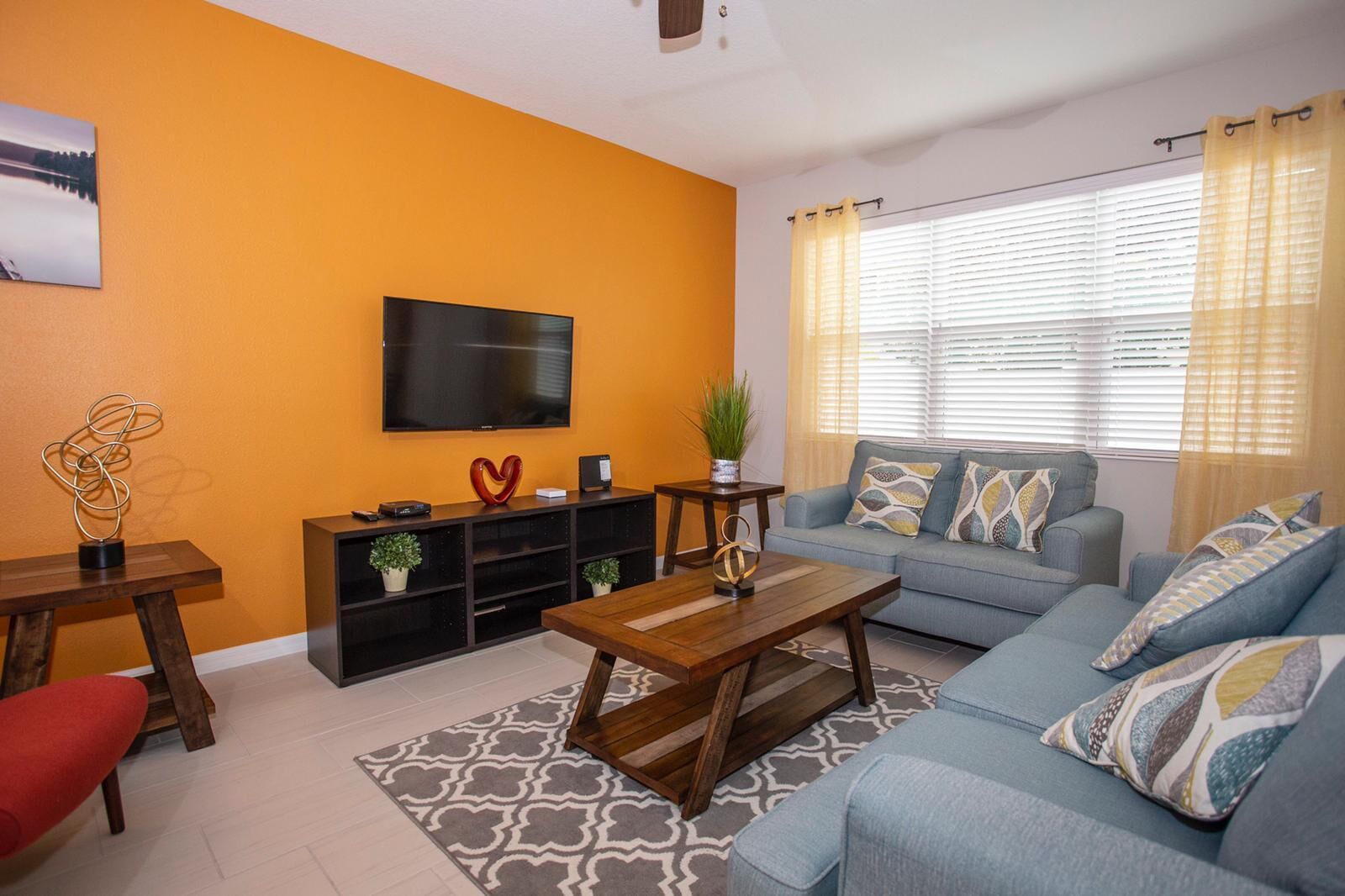 A living room with a sofa, coffee table, TV, and decorative items.