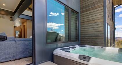 Updated home with a private hot tub, fireplace, & mountain views - dog friendly