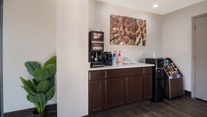 A modern kitchen with a coffee maker, a refrigerator, and a potted plant. - Red Roof Inn Rocky Mount - Battleboro (Battleboro)