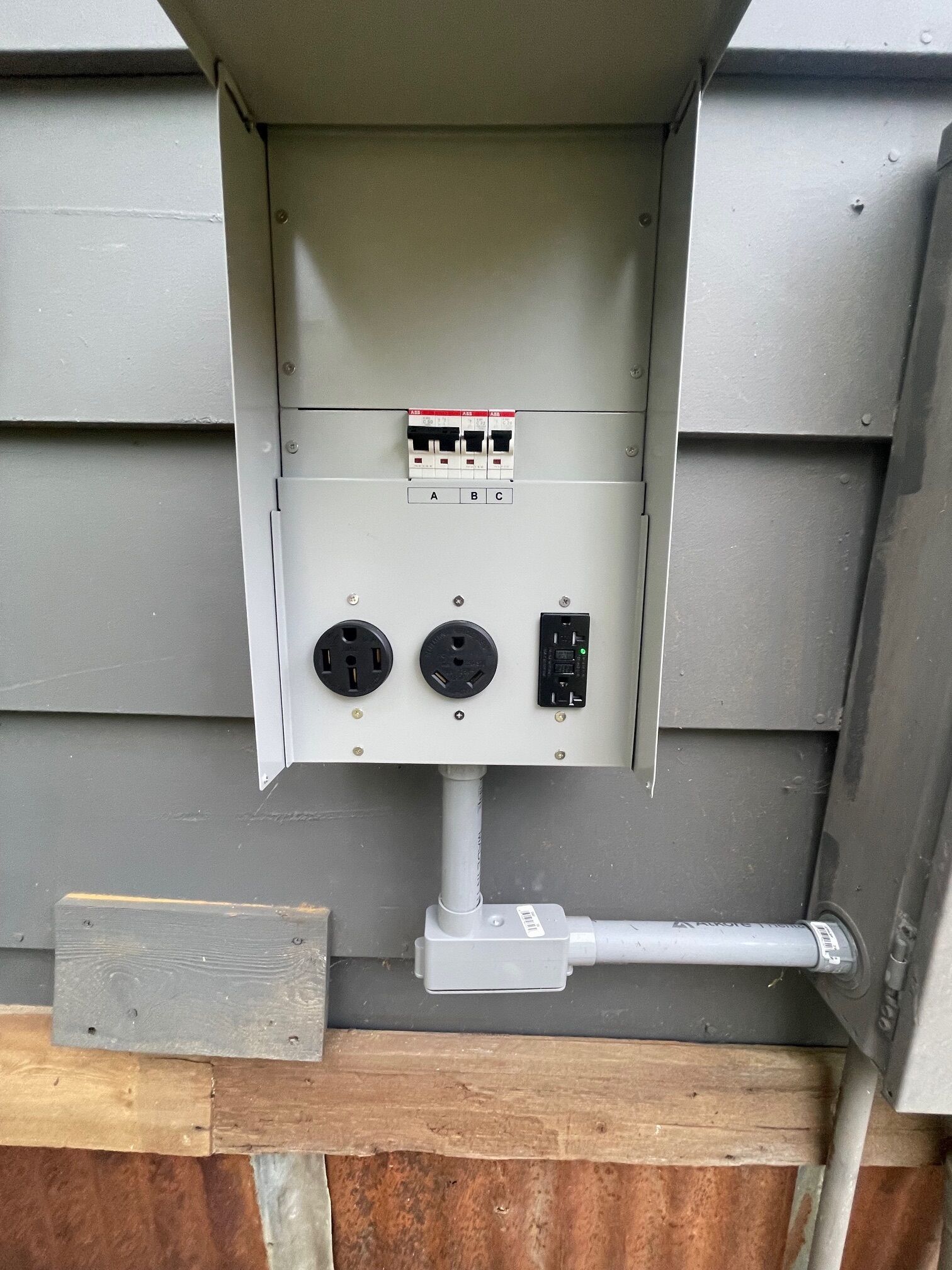 An electrical panel with three switches and two sockets.