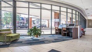 A modern lobby with large windows, a reception desk, and seating area. - Holiday Inn Express & Suites Platteville (Platteville)