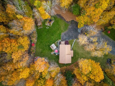 Cabin rental with Hot Tub, Fire Pit, mini fountain pond, hammocks, corn hole.