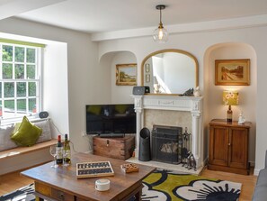 A living room with a fireplace, television, and seating area.