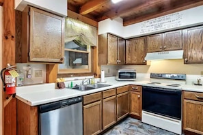 Fully equipped kitchen with an oven, dishwasher, and microwave.