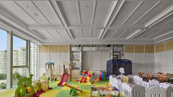 Children can play safely on interlocking foam mats beneath a playhouse, climbing frames, and slides.