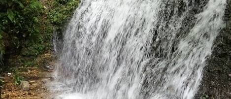 A waterfall cascading over rocks in a natural setting.