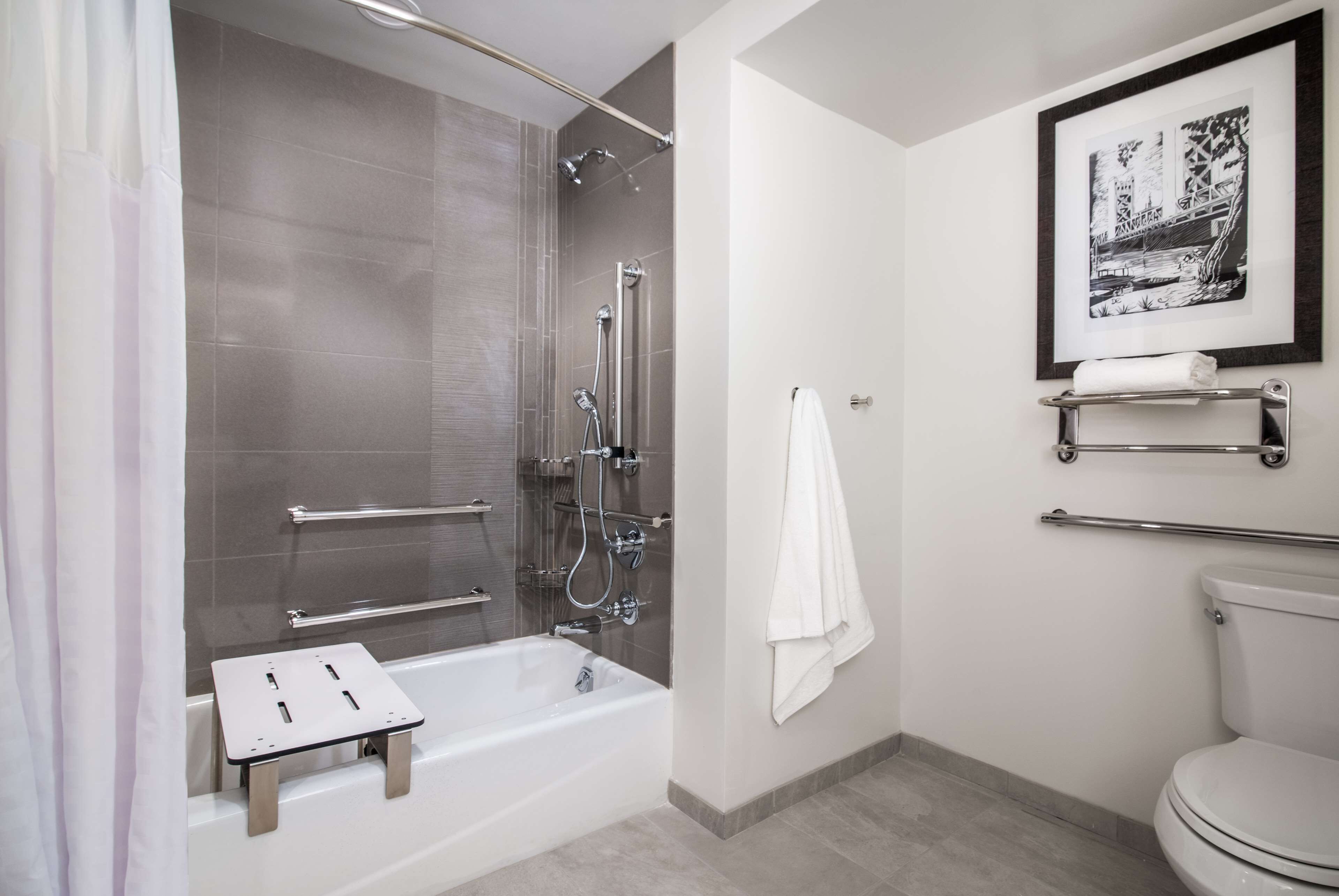 A modern bathroom with a walk-in shower, a bathtub, and a toilet.