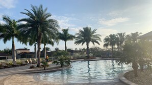 A swimming pool with palm trees and lounge chairs. - New Elegant Vacation Home in Fabulous Fort Myers (Fort Myers)