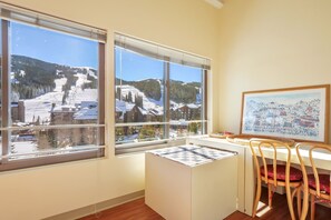 Enjoy breathtaking views of the surrounding ski slope from the large window in this cozy retreat.