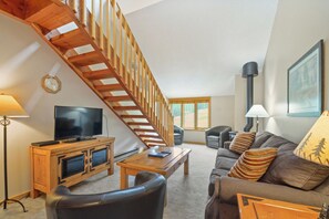 Relax in this inviting living room with a flat-screen TV, comfortable sofa, and coffee table.