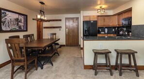 Enjoy meals at the central island or dining table in this kitchen.